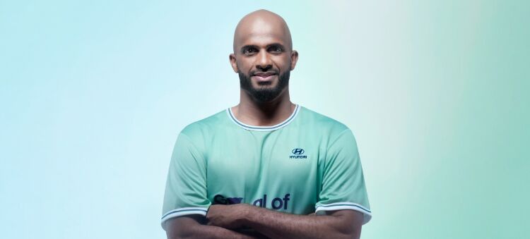 Ali Al-Habsi, the Omani football legend, is staring at the camera with his arms folded.