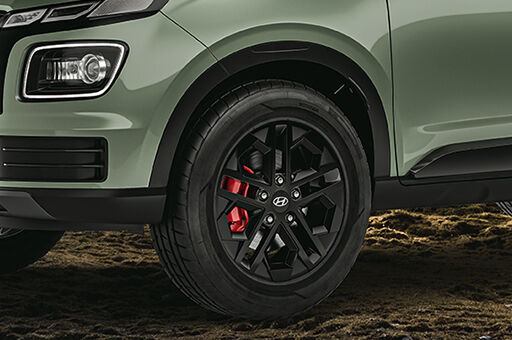 Black painted alloy wheel with red front brake caliper