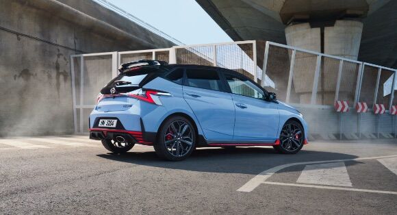 Rear view of a blue Hyundai i20 N in a carpark. 