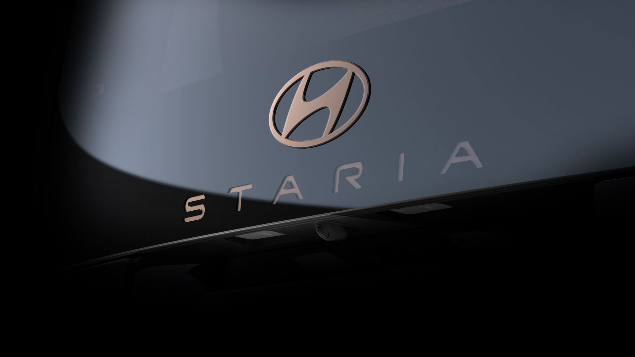 The rear Hyundai STARIA logo.